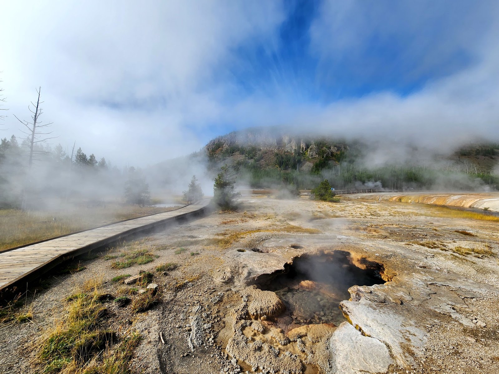 basin in yellowstone emitting white steam