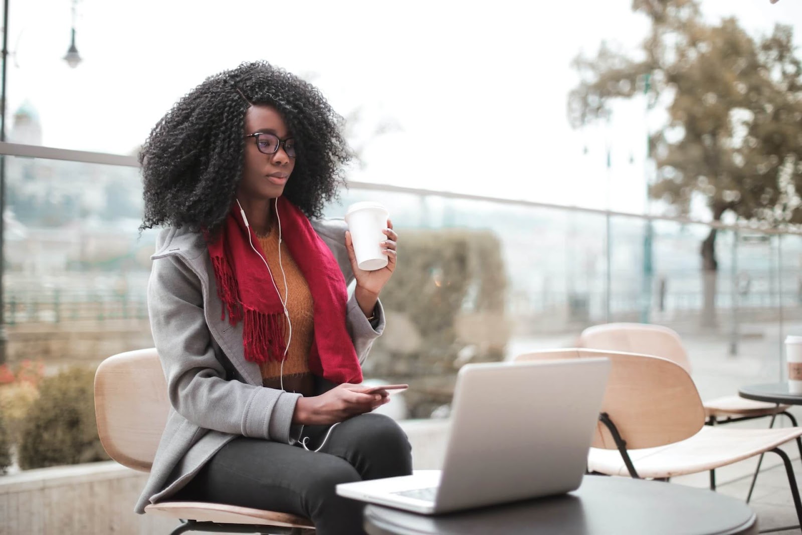 Woman looking at her laptop outside