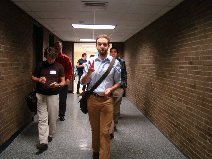 Faculty members walk down the hall after attending orientation