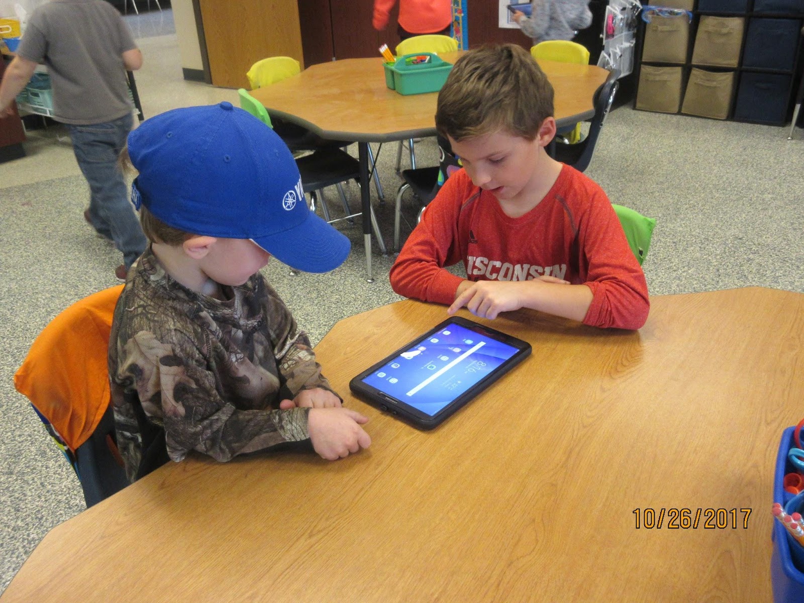 Students reading together from Seesaw