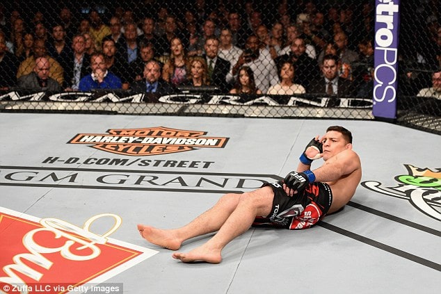 Nate Diaz laying down in octagon