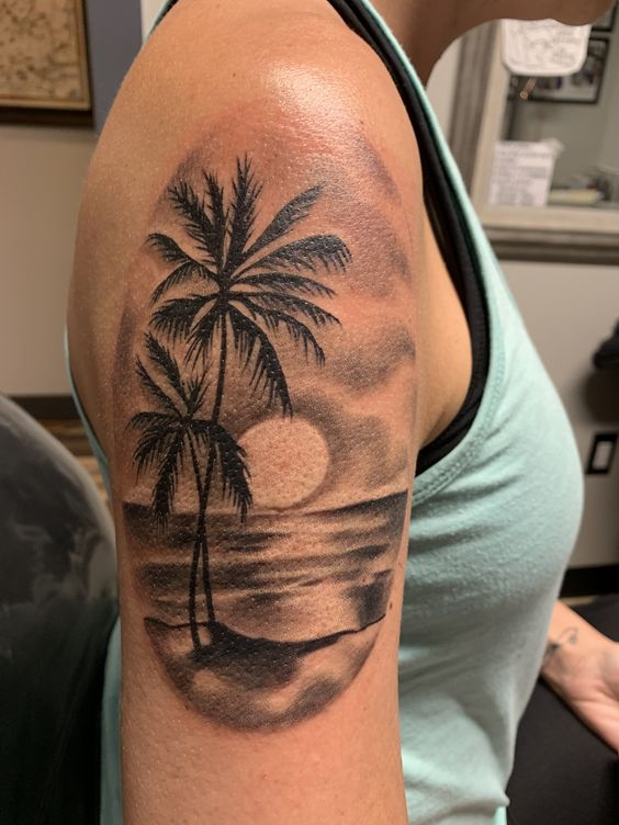 Another view of a lady rocking the shoulder palm tree tat 