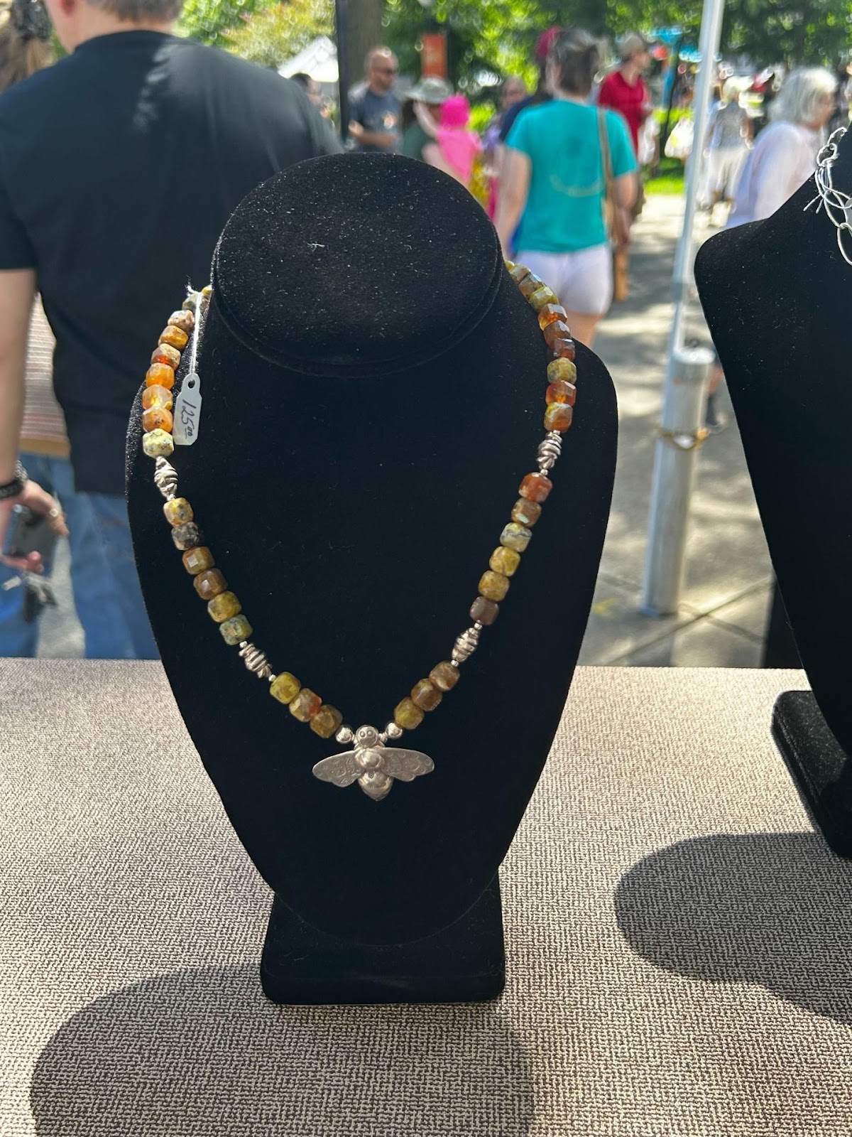 A necklace on a mannequin

Description automatically generated