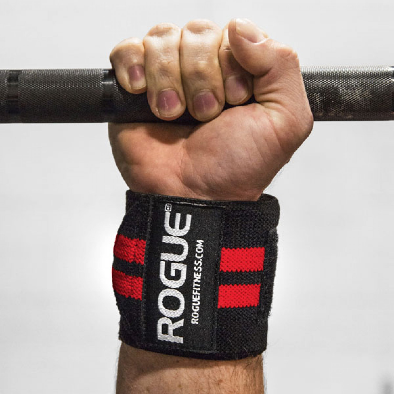 wrist wrap on a person's wrist with hand holding a barbell
