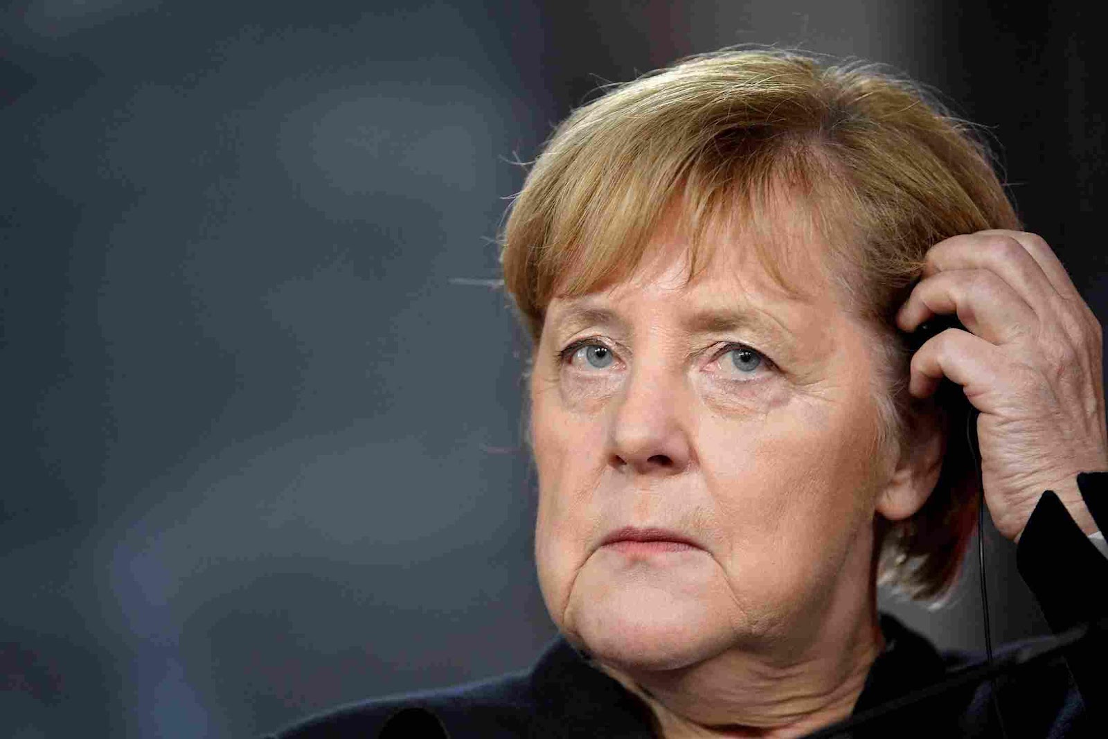 A person with short blonde hair

Description automatically generated