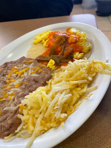 Huevos Ranchos (eggs with salsa), beans, and hash browns.