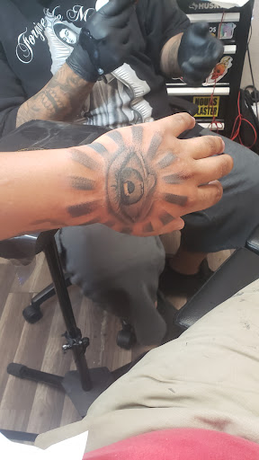 Explore fist tattoo ideas, creative tattoo ideas in Glendale, available at Urban Legends Tattoo and Piercing LLC