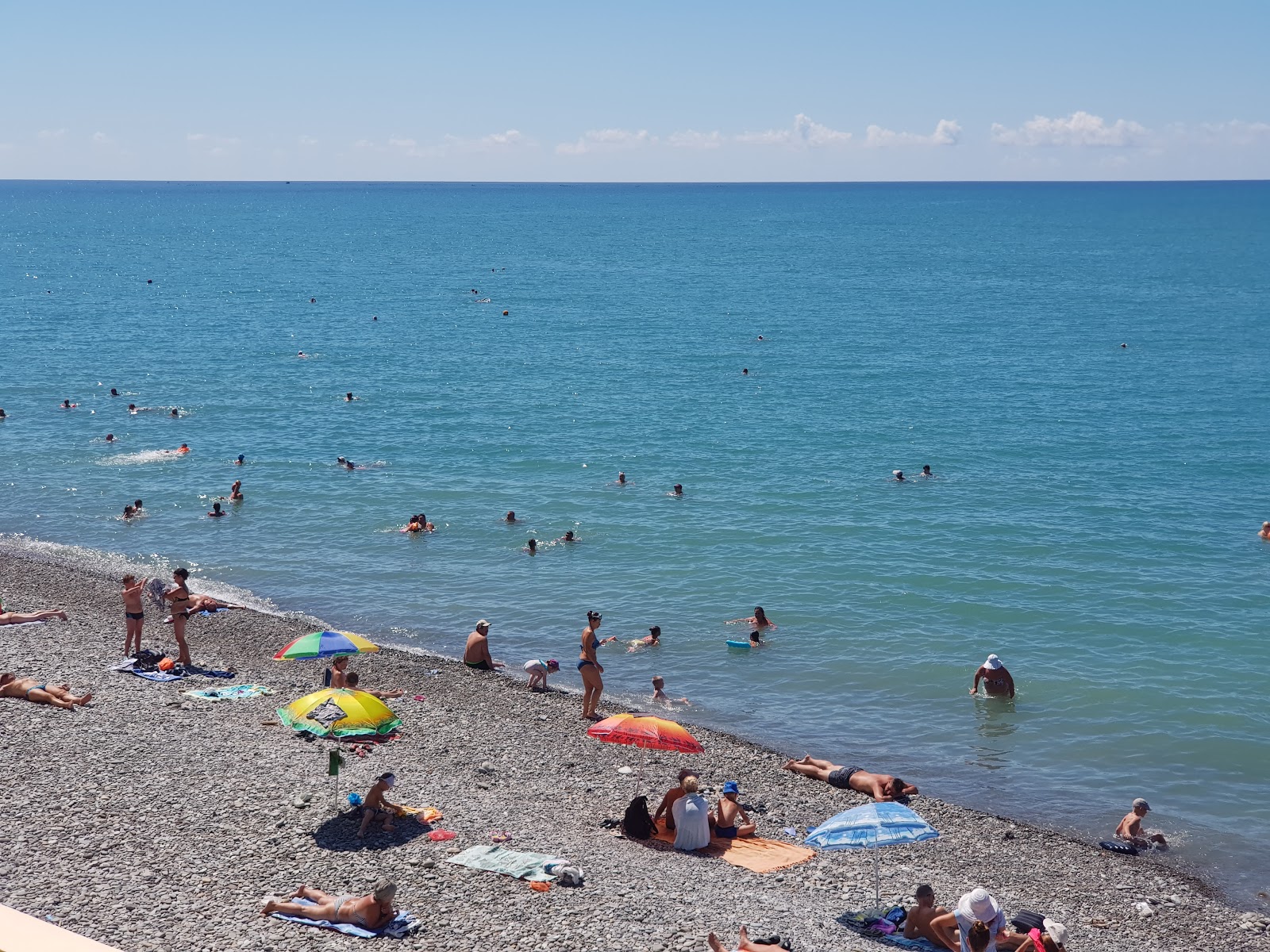 Photo of French Riviera beach with gray sand &  pebble surface