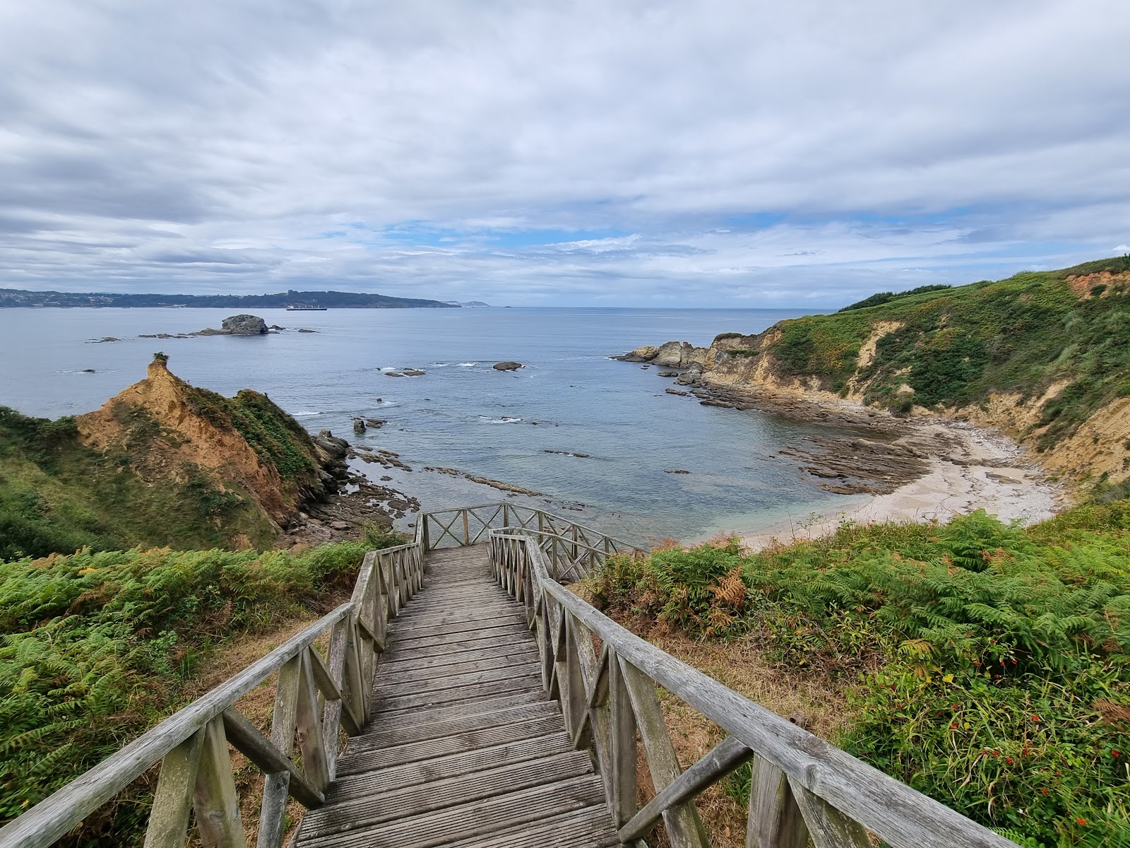 Foto di Praia da Barrosa con una superficie del sabbia beige e rocce