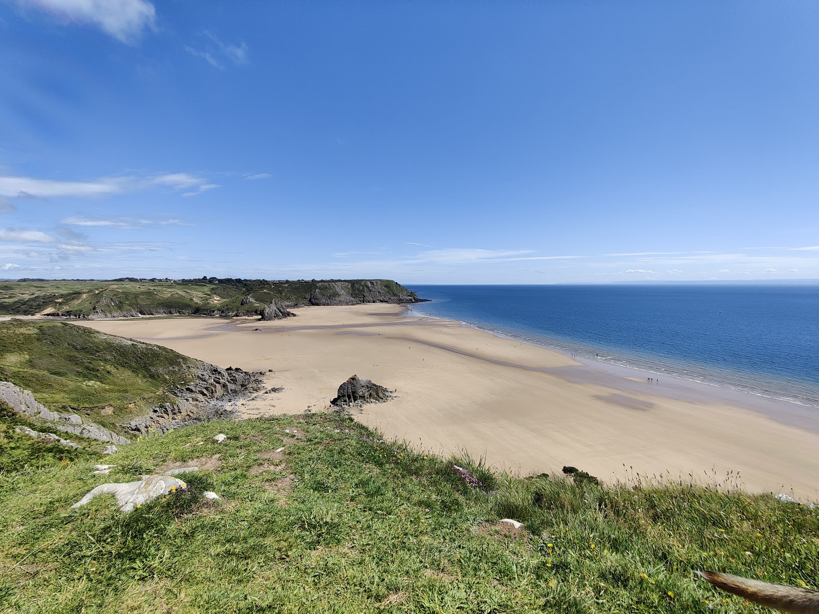 Photo of Oxwich Bay beach with blue pure water surface