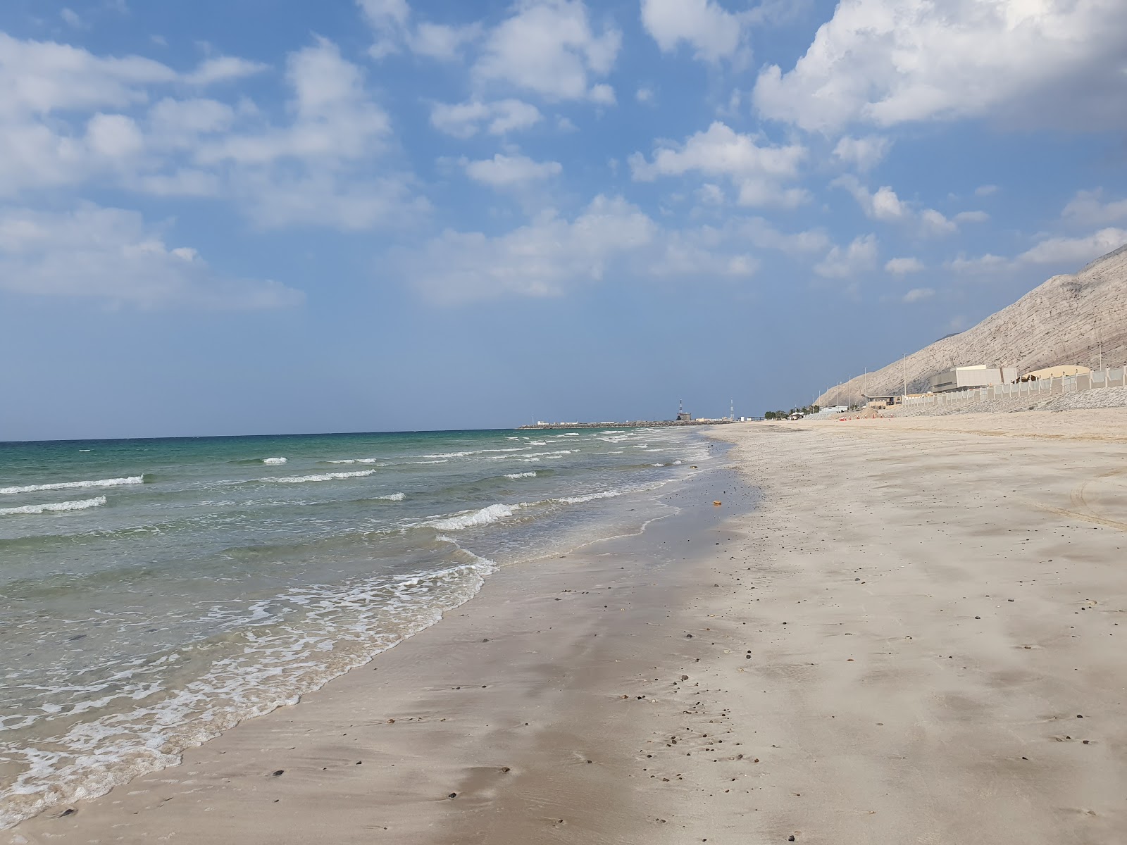 Shaam beach'in fotoğrafı mavi saf su yüzey ile