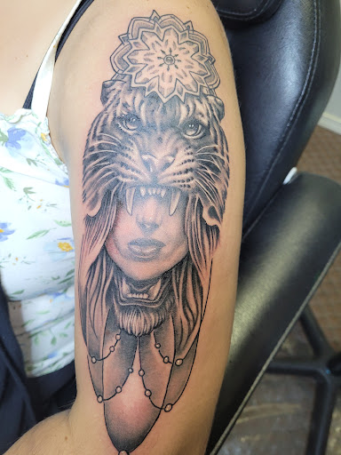 Find under breast tattoo ideas for your next unique tattoo in Angola at Hoodlum Ink