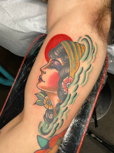 Explore male bicep tattoo ideas, creative tattoo ideas in Edgewood, available at Wild Coyote Tattoo