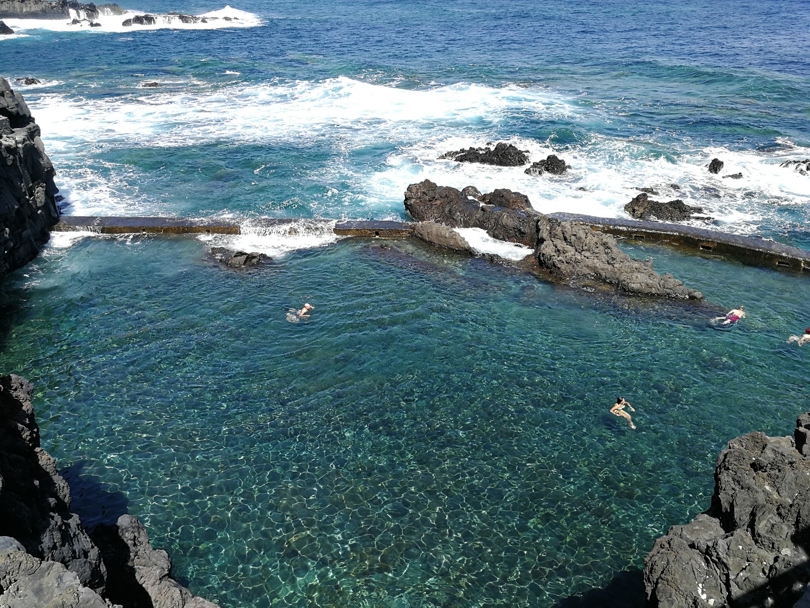 Photo of Piscinas de La Fajana with turquoise pure water surface