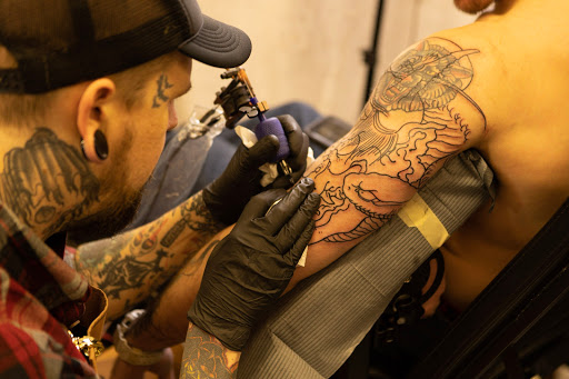 Explore under breast tattoo ideas for females, creative tattoo ideas in Canton, available at The Inkeepers Tattoo Parlor