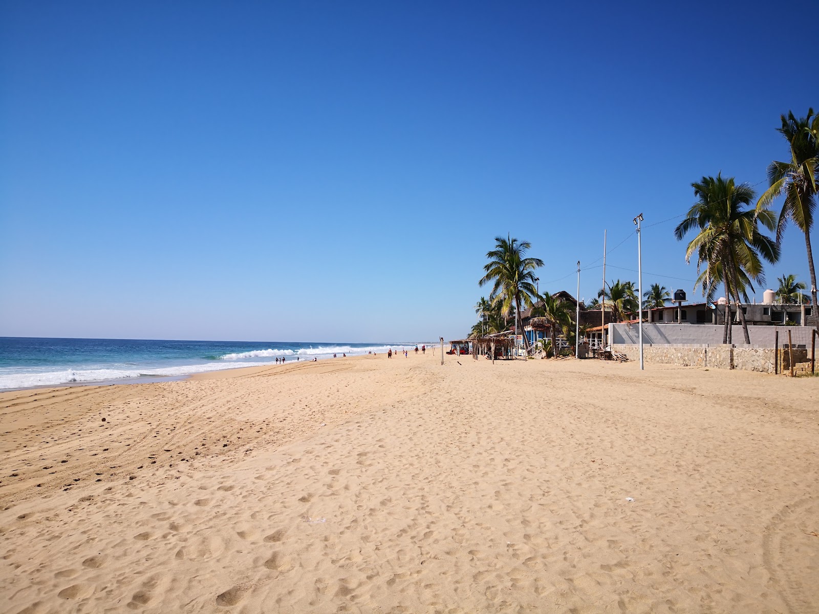 Foto av Playa Pie de La Cuesta med ljus sand yta