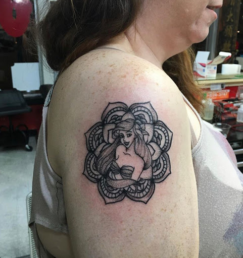 Explore book dragon tattoo ideas, creative tattoo ideas in Kansas City, available at Grimm Tattoo and Bert Grimm Museum