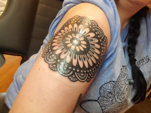 Explore spartan helmet tattoo ideas, creative tattoo ideas in Canton, available at The Inkeepers Tattoo Parlor