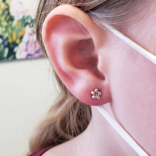 Explore tattoo ideas for women's lower back, creative tattoo ideas in Bellevue, available at Just Your Ears Piercing & Permanent Jewelry Studio