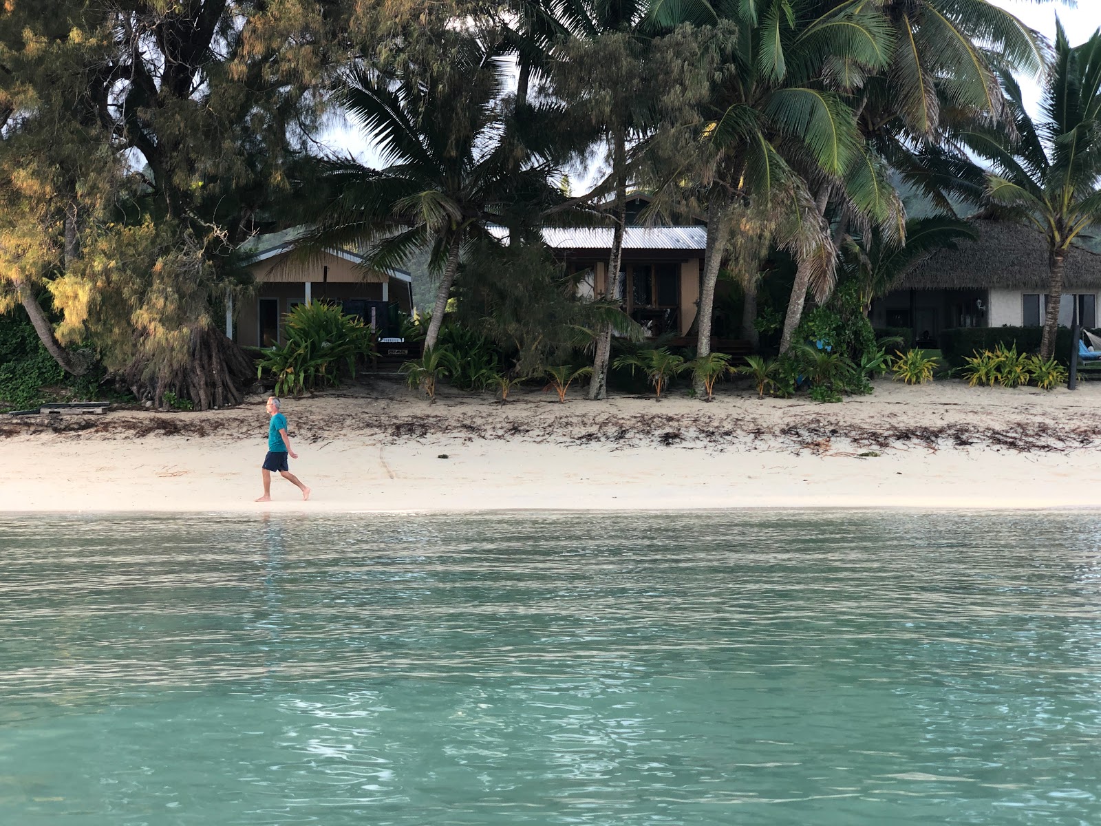 Photo of Titikaveka Beach with turquoise pure water surface