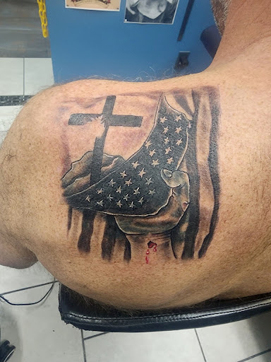 Explore men's behind the ear tattoo ideas, creative tattoo ideas in Foley, available at Symbolic Ink Tattoo Studio