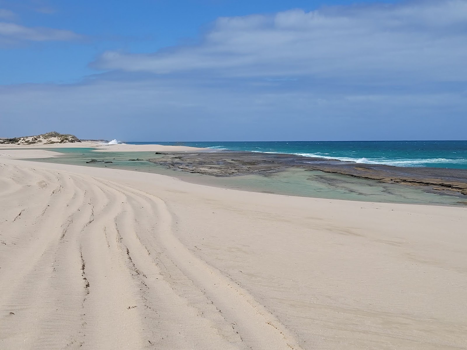 Foto van Wagoe Beach met helder fijn zand oppervlakte
