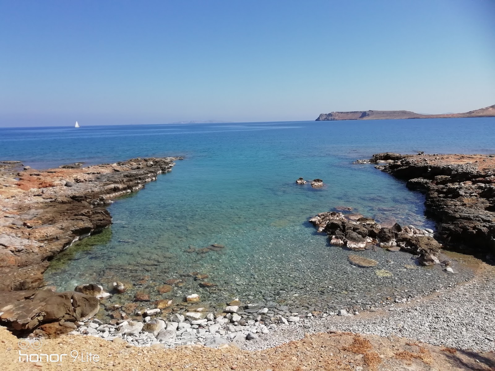 Foto von Varkotopos beach mit steine Oberfläche