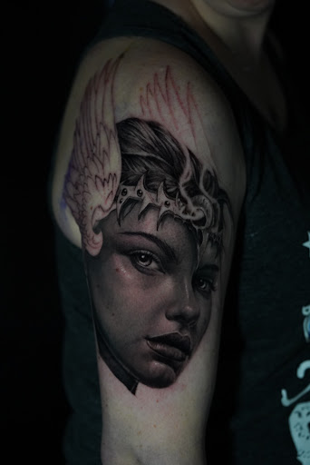 Explore hood tattoo ideas, creative tattoo ideas in Burlington, available at Insidious Studios