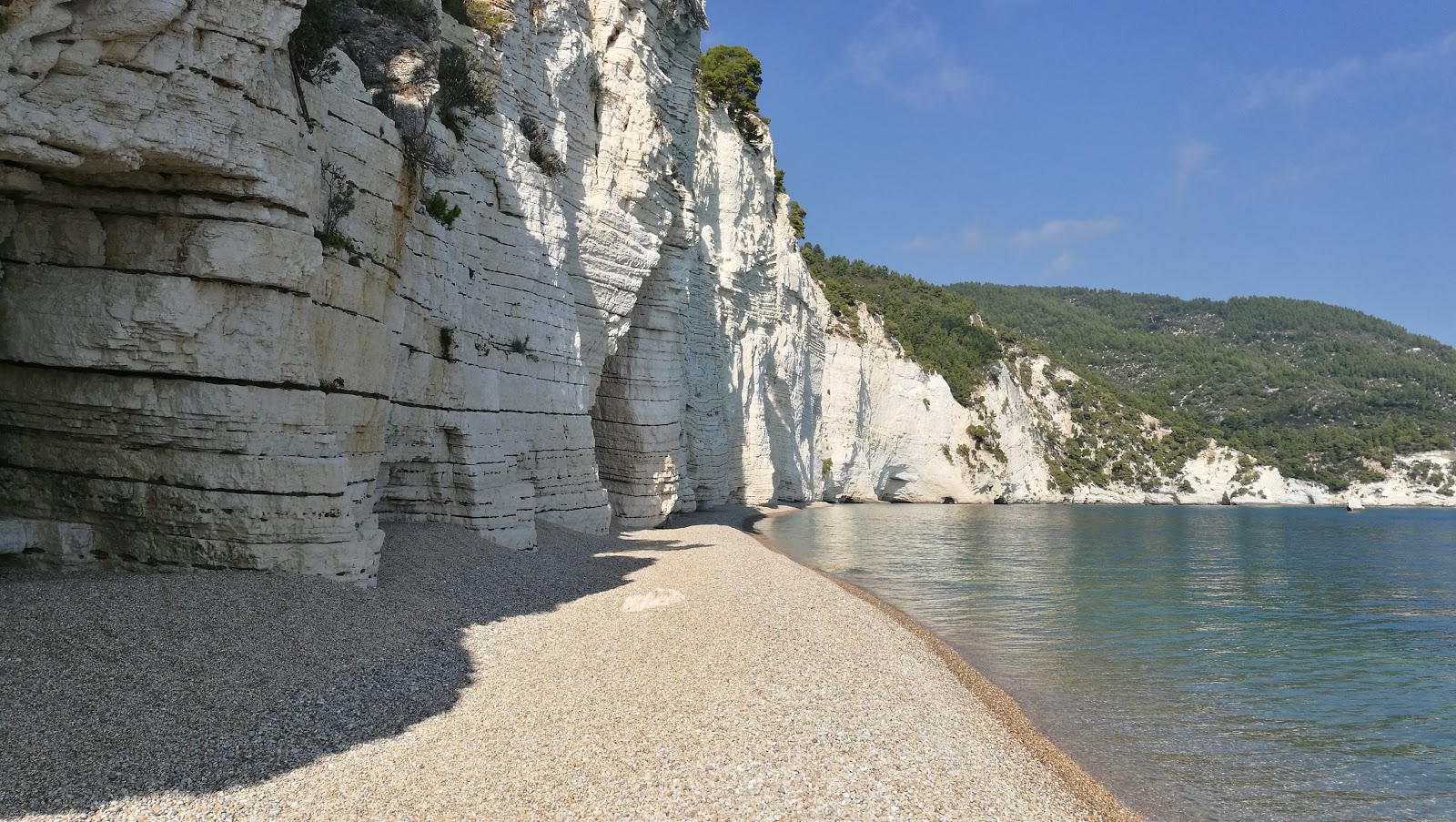 Foto di Cala della Cattedrale con una superficie del sabbia beige