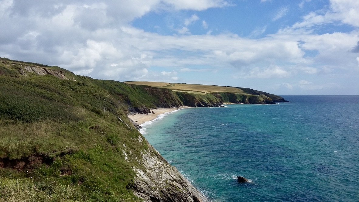 Photo of Porthbeor beach with gray sand surface