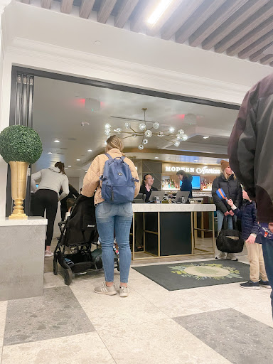 People wait in line to get in.