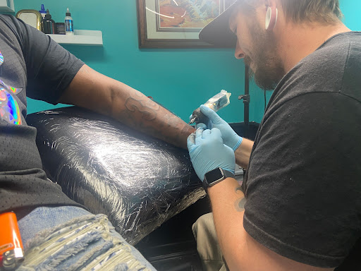 Explore red string tattoo ideas, creative tattoo ideas in Valdosta, available at Urban Ink Body Art