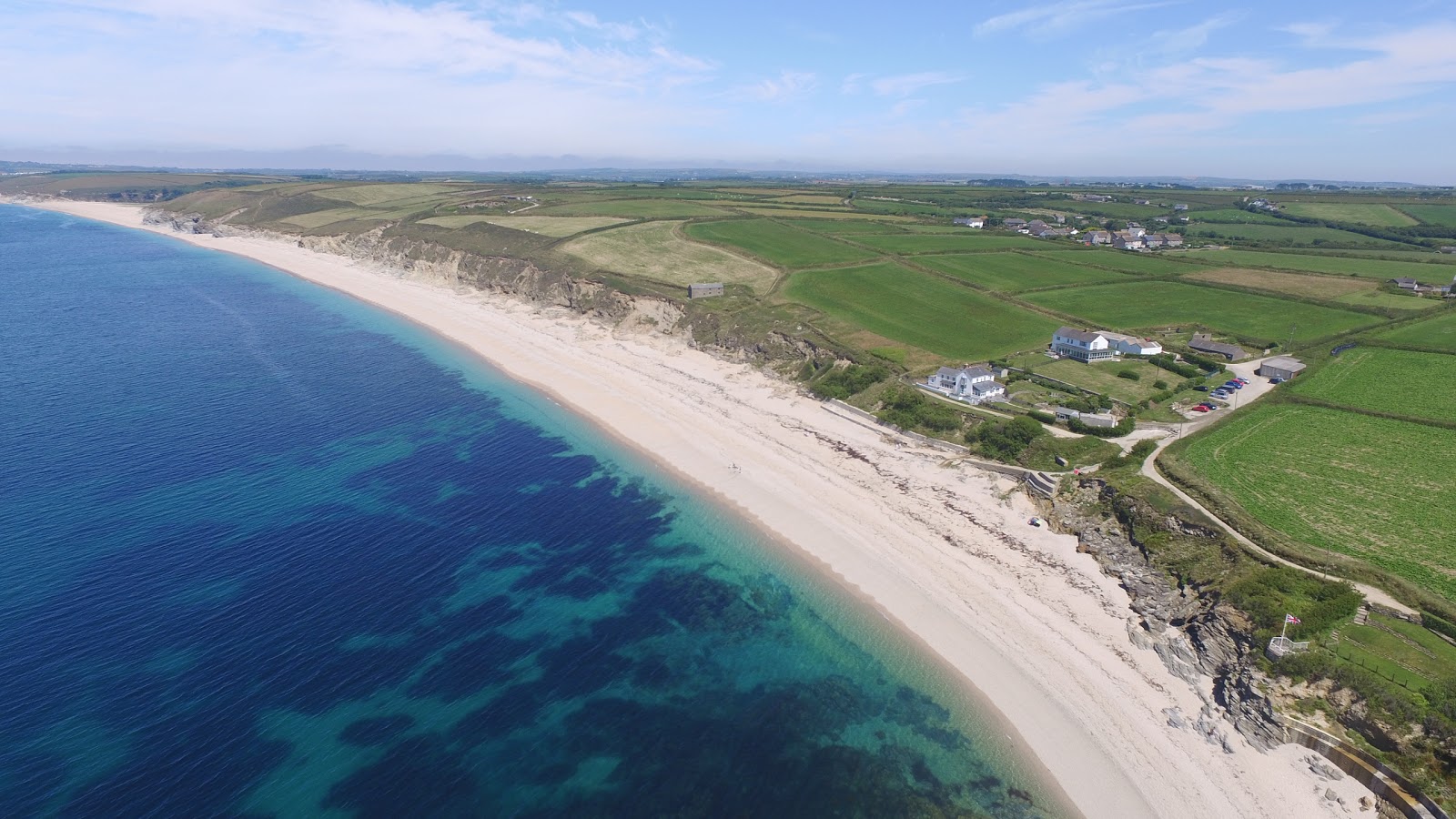 Photo of Gunwalloe beach with turquoise pure water surface