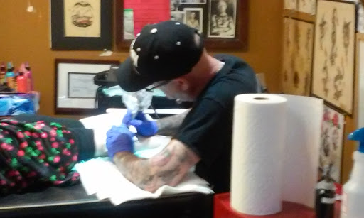 Explore male bicep tattoo ideas, creative tattoo ideas in Kansas City, available at Grimm Tattoo and Bert Grimm Museum