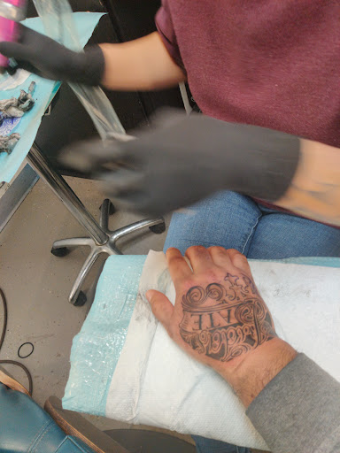 Explore red ink neck tattoo ideas, creative tattoo ideas in Norman, available at Studio Ink