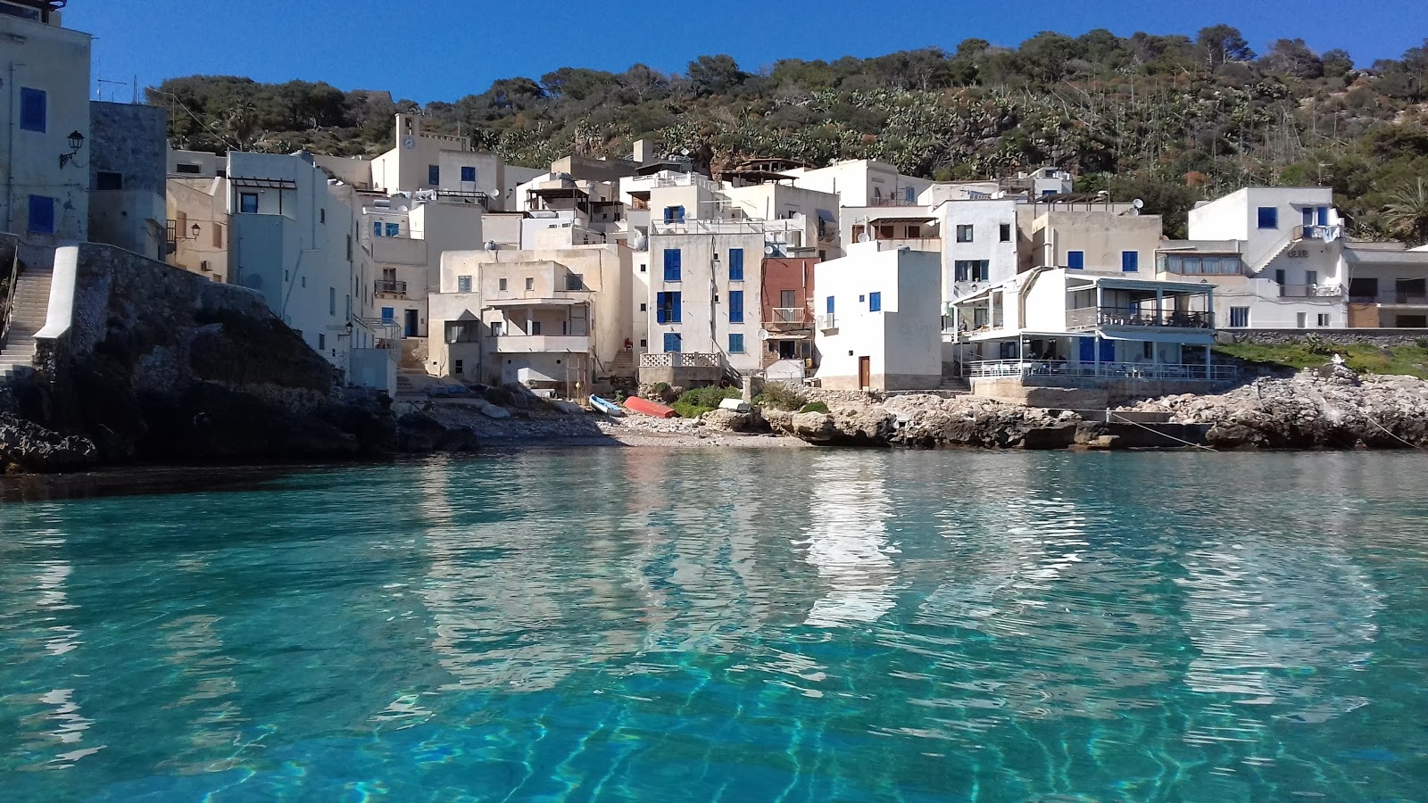 Foto av Cala Dogana beach med liten vik