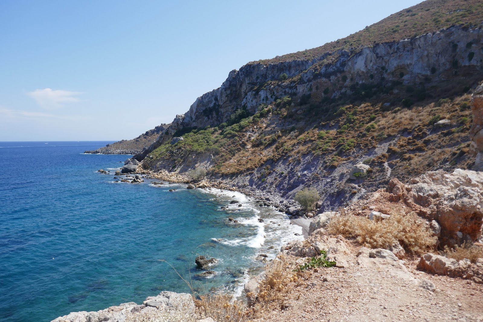 Photo of Faros Bar beach with gray sand &  rocks surface