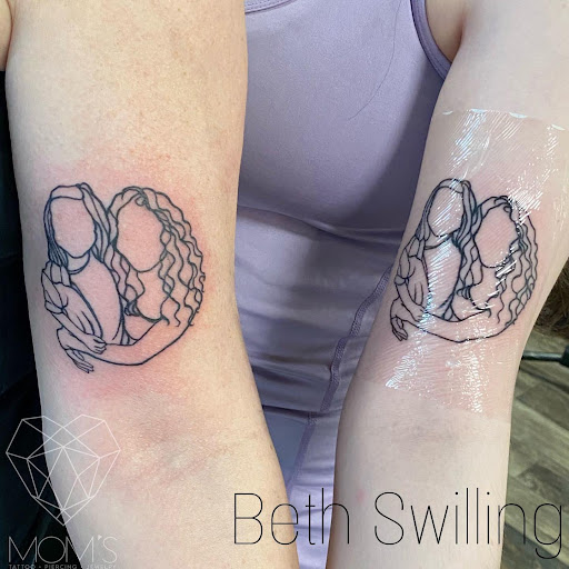 Explore cat and dog tattoo ideas, creative tattoo ideas in Spokane, available at Moms Custom Tattoo & Body Piercing