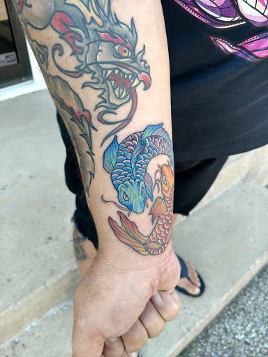 Explore marriage ring tattoo ideas, creative tattoo ideas in Erie, available at Wayward Tattoo Studio