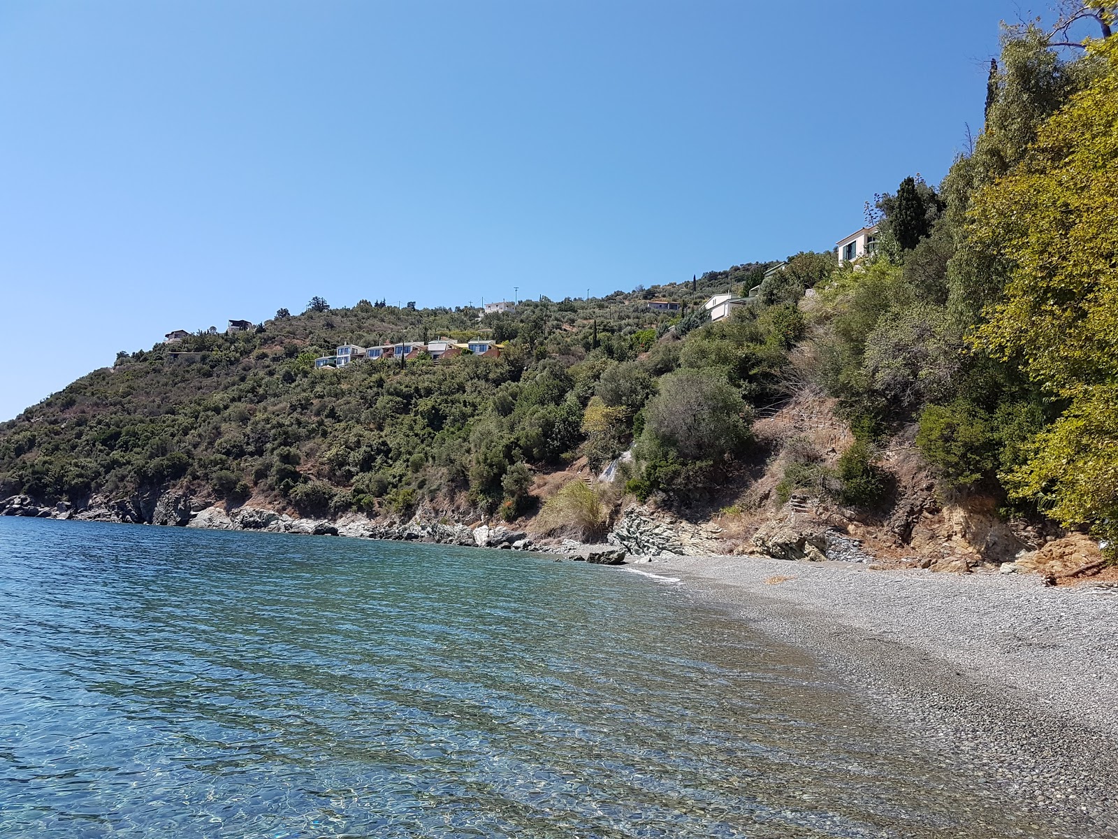 Foto di Kissakas Beach con una superficie del sabbia beige e ciottoli