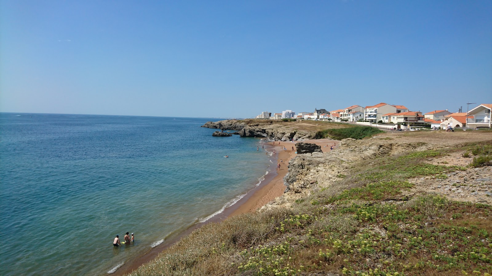 Photo of Bussoleries beach with bright sand & rocks surface