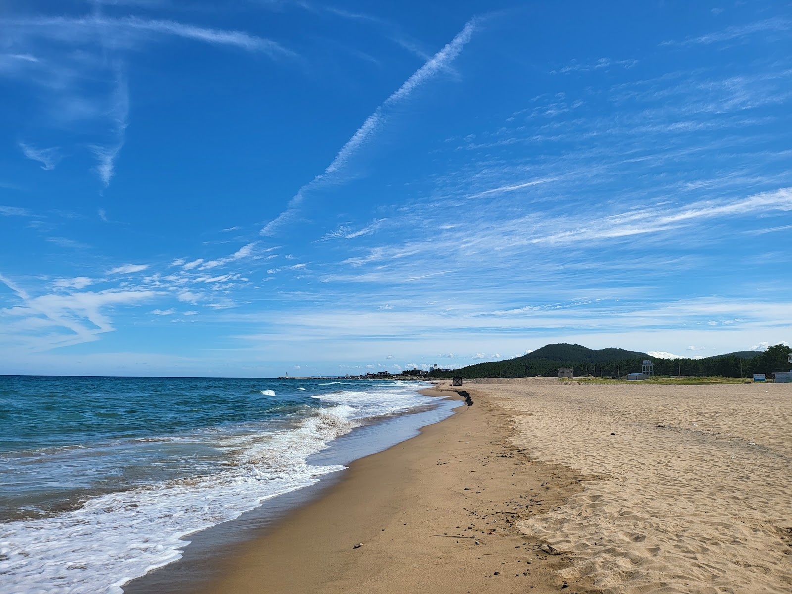 Photo of Hwajin Beach with long straight shore