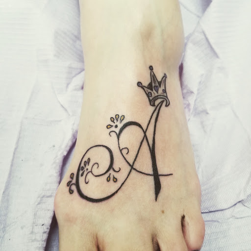 Explore tattoo ideas for women leg, creative tattoo ideas in Frisco, available at Frisco Tattoo Company - Steel PaintBrush