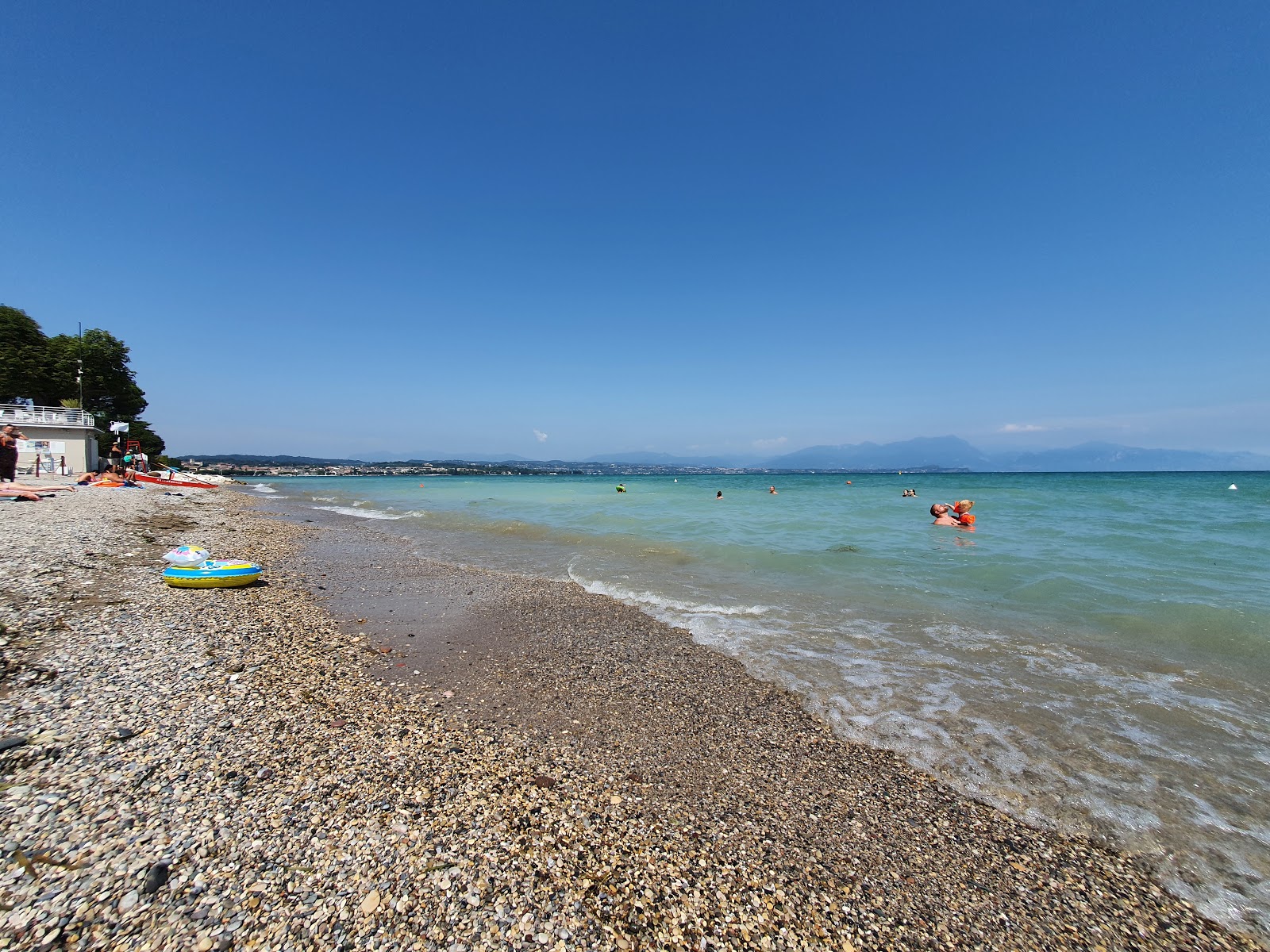 Photo de Spiaggia Cala de Or avec l'eau turquoise de surface