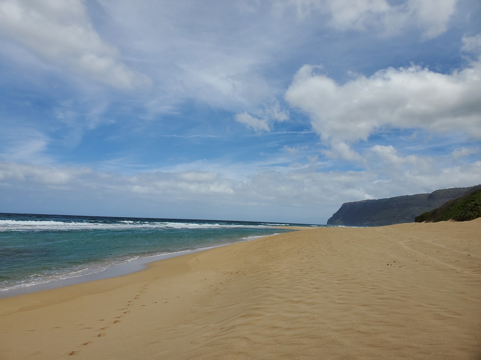 Photo of Polihale State Beach backed by cliffs