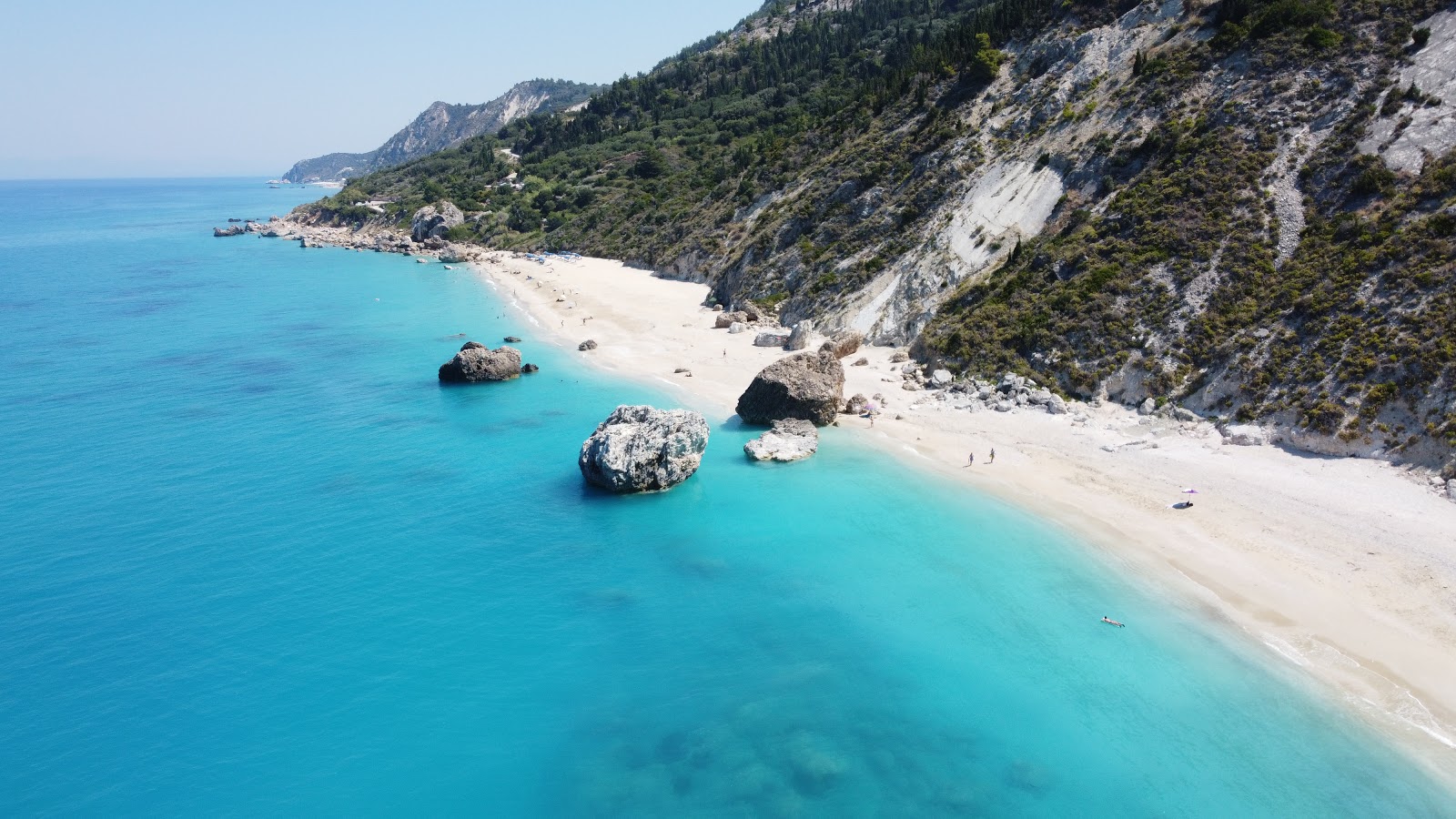 Photo of Komilio beach with turquoise pure water surface