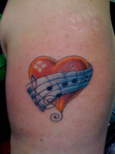 Find between the boob tattoo ideas for your next unique tattoo in Seaside at Creative Visions Ink Tattoo & Body Piercing Studio - Call for Appointment