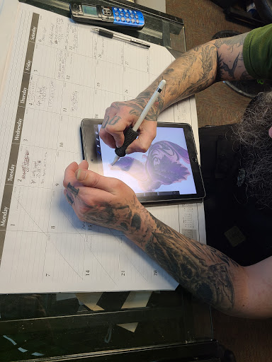 Explore mens behind the ear tattoo ideas, creative tattoo ideas in Decatur, available at Exclusive Ink Tattoos & Body Piercings 22nd & Wood