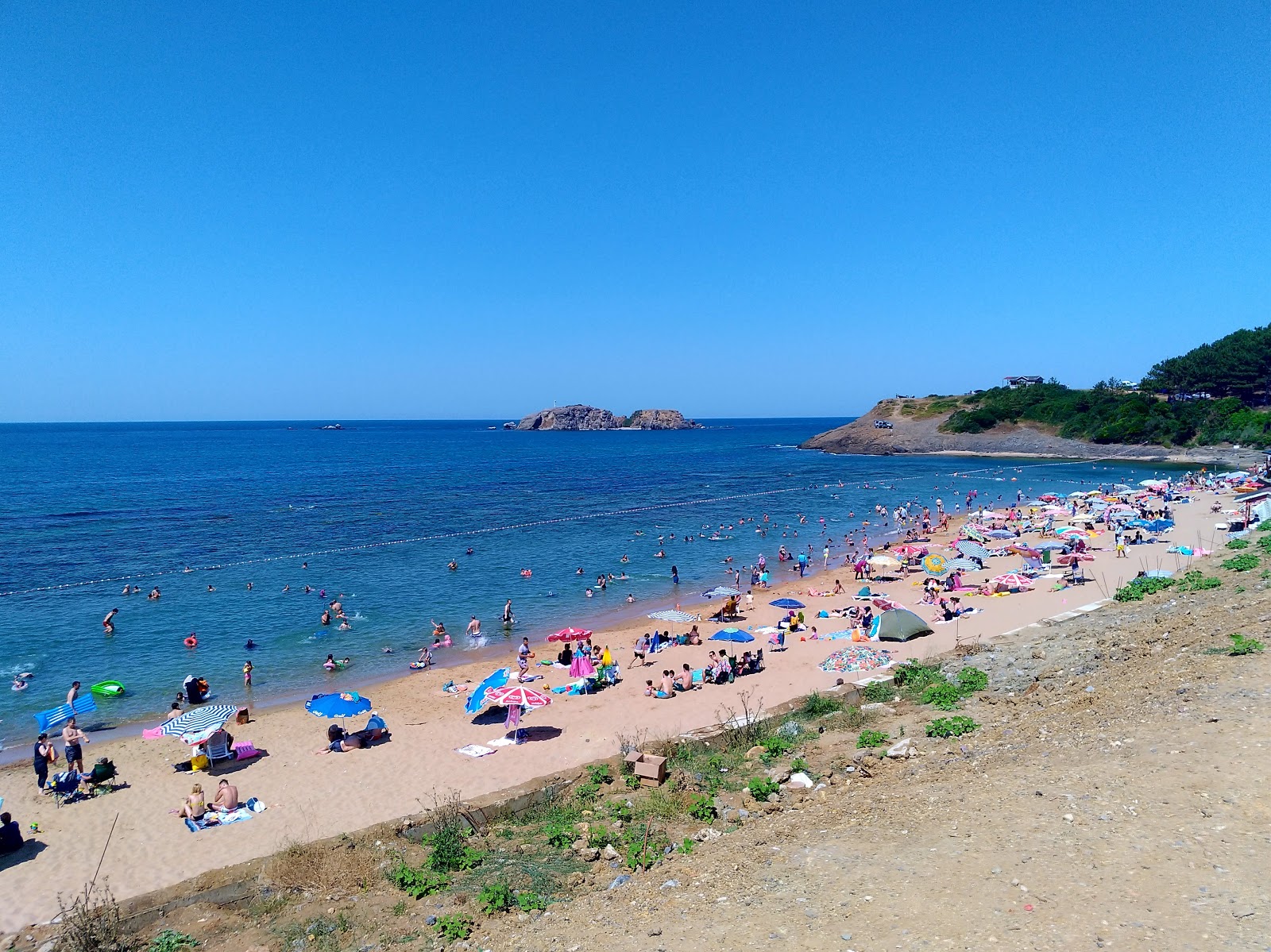 Foto von Elmasburnu kadinlar Plaji umgeben von Bergen