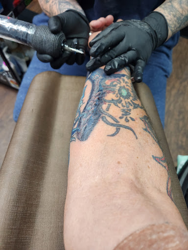 Explore gangster tattoo ideas for men, creative tattoo ideas in Broxton, available at Seratonin Tattoo Parlor